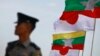 A police officer stands on guard near national flags of Myanmar and Japan during the commencement ceremony of the Thilawa Special Economic Zone (SEZ) project in the Japanese Special Economic Zone at Thilawa outside Yangon November 30, 2013. The first pha