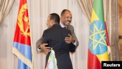 Ethiopian Prime Minister Abiy Ahmed and Eritrean President Isaias Afwerk embrace at the declaration signing in Asmara, Eritrea, July 9, 2018, in this photo obtained from social media. (Ghideon Musa Aron Visafric)
