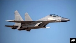 In this undated file photo released by the Taiwan Ministry of Defense, a Chinese PLA J-16 fighter jet flies in an undisclosed location. China sent a record 28 fighter jets, 14 of them J-16s, towards the self-ruled island of Taiwan on June 15, 2021.