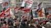 People carry posters of Russian President Vladimir Putin during a rally against a new law banning American adoptions of Russian children, Moscow, January 13, 2013. 