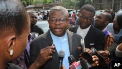 Priest Donatien Nshole, First Deputy Secretary-General of the National Episcopal Commission, speaks to journalists after a meeting in Kinshasa, Democratic Republic of Congo, Wednesday, Dec. 21, 2016. Mediators urged Congo's president and opposition parties Wednesday to reach an agreement before Christmas on a peaceful settlement to the country's political crisis, saying dozens already have been killed this week amid protests over the president's stay in power.