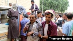 A man injured by an air strike on a market in Yemen's Saada province arrives at a hospital to receive medical attention, July 29, 2019. 