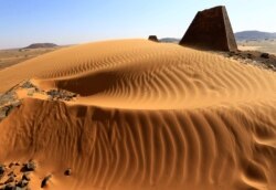 Creeping desert sands surround the Royal Cemeteries of Meroe Pyramids in Begrawiya at River Nile State, Sudan, Nov. 10, 2019.