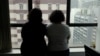 FILE - Sisters from Saudi Arabia, who go by aliases Reem and Rawan, are pictured at an office in Hong Kong, China, Feb. 23, 2019.