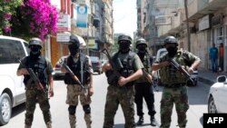 Palestinian militants of al-Nasser Salah al-Deen Brigades, the armed wing of the Popular Resistance Committees (PRC), give a press conference in Gaza City , July 5, 2014. 
