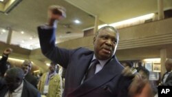 Phelekezela Mphoko chants the partys slogan at the Zanu pf headquarters in Harare,Wednesday, Dec, 10, 2014. Phelekezela Mphoko and Justice Minister Emmerson Mnangagwa were both announced as vice Presidents following a cabinet reshuffle. (AP Photo/Tsvangirayi Mukwazhi)