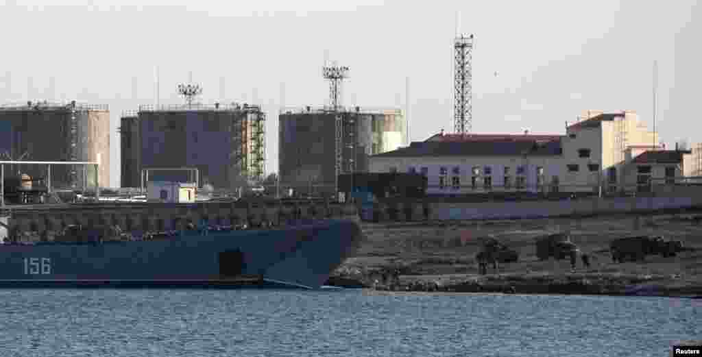 Trucks drive out of Russian landing craft Yamal 156 near the Crimean port of Sevastopol, March 14, 2014.