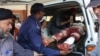 FILE - Pakistani volunteers carry an injured person who arrived from Mardan, at a local hospital in Peshawar, Pakistan, Sept. 2, 2016.