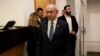raeli Prime Minister Benjamin Netanyahu enters the district court in Tel Aviv at the start of his hearing on corruption charges on December 10, 2024.