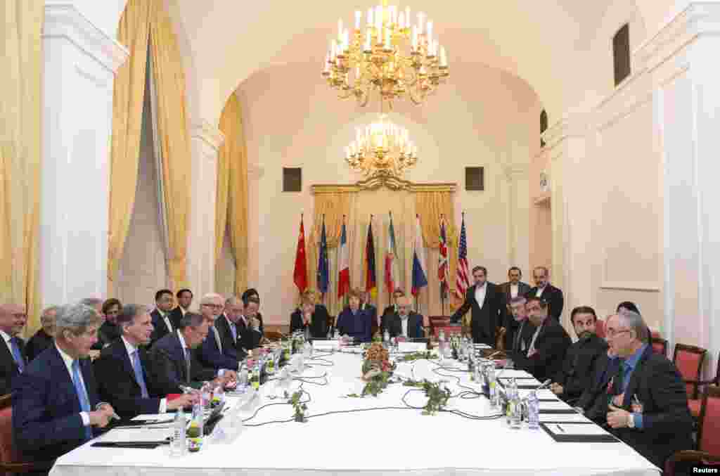 Delegations of U.S. Secretary of State John Kerry, Britain&#39;s Foreign Secretary Philip Hammond, Russian Foreign Minister Sergei Lavrov, German Foreign Minister Frank-Walter Steinmeier, French Foreign Minister Laurent Fabius, Chinese Foreign Minister Wang Yi, EU High Representative Catherine Ashton, and Iranian Foreign Minister Javad Zarif&nbsp;sit around the negotiations table during their meeting in Vienna, Nov. 24, 2014.