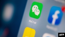 FILE - This illustration picture taken on July 24, 2019, in Paris shows the logo of the Chinese instant messaging application WeChat on the screen of a tablet.