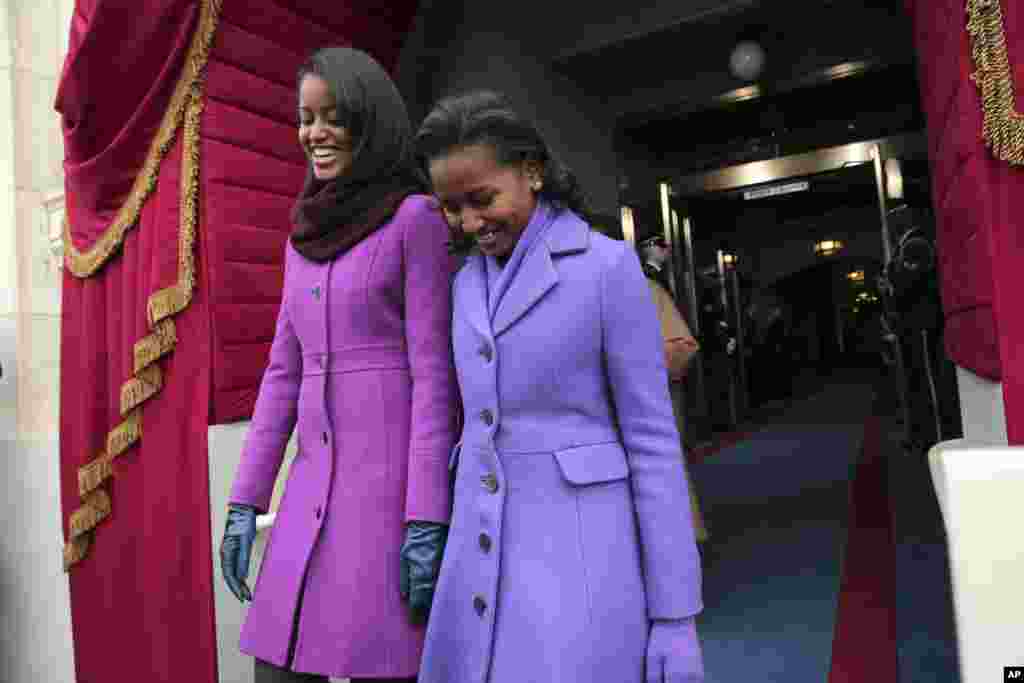 President Barack Obama's daughters Malia Obama, left, and Sasha Obama arrive on the West Front of the Capitol in Washington, Jan. 21, 2013, for the president's ceremonial swearing-in.
