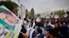 Supporters gather outside the National Assembly to celebrate Prime Minister Imran Khan winning a vote of confidence in Islamabad, Pakistan, March 6, 2021.