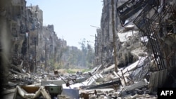 FILE - Destruction is seen at the Yarmouk Palestinian refugee camp near the Syrian capital, Damascus, April 6, 2015. 