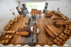 FILE - Coffins with coronavirus victims arrive from the Bergamo area, where they are unloaded from a military truck that transported them to a cemetery near Milan, northern Italy, March 27, 2020.