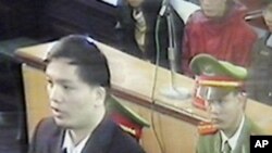Human rights lawyer Nguyen Van Dai, left, is seen in this picture shot through close-circuit TV set up in the court during his trial in Hanoi, Vietnam Tuesday, Nov. 27, 2007.