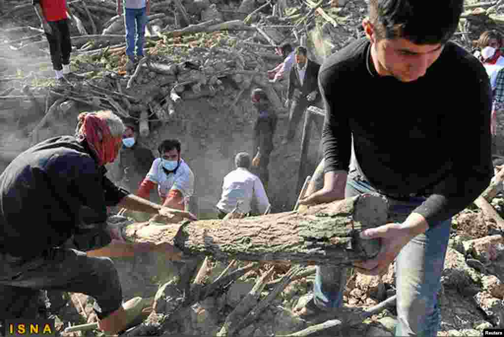Rescue teams search for victims in Varzaqan near Ahar. Iran's government faced criticism from lawmakers and the public on its handling of relief efforts, August 12, 2012.