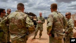 FILE - U.S. Army Brig. Gen. Damian T. Donahoe, deputy commanding general, Combined Joint Task Force-Horn of Africa, center, talks with service members during a battlefield circulation, Sept. 5, 2020, in Somalia.