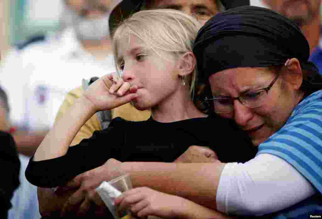 Relatives and friends mourn during the funeral of Israeli girl, Hallel Yaffa Ariel, 13, who was killed in a Palestinian stabbing attack in her home in the West Bank Jewish settlement of Kiryat Arba, at a cemetery in the West Bank city of Hebron.