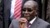 File - Zimbabwe President Robert Mugabe listens after a swearing-in ceremony at the State House in Harare, Zimbabwe.