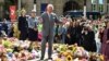 Britain's King Charles III reacts as he views tributes outside Southport Town Hall during his visit to meet with members of the community following the July 29 attack at a children's dance party in Southport, U.K., on Aug. 20, 2024.