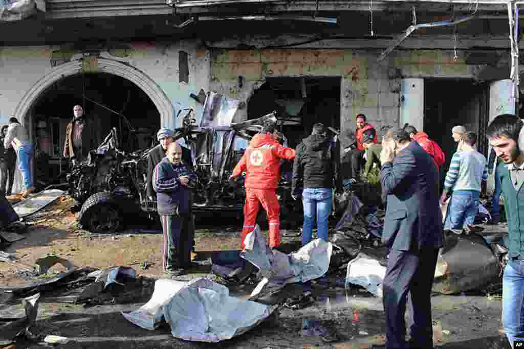 People gather at the site of a car bomb explosion in Hermel, northeast of Lebanon, Jan. 16, 2014.