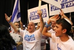 FILE - Supporters of Israeli Prime Minister Benjamin Netanyahu's Likud party react to exit polls in Israel's parliamentary election at the party headquarters in Tel Aviv, Israel, Sept. 17, 2019.