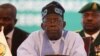 Chairperson of Economic Community of West African States (ECOWAS) and President of Nigeria, Bola Ahmed Tinubu, reacts while addressing the ECOWAS head of states and government in Abuja on July 30, 2023