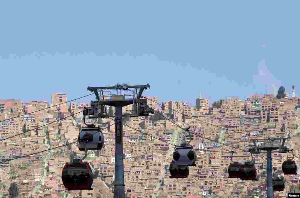 Cable cars decorated to look like soccer balls are seen over La Paz city, Bolivia.