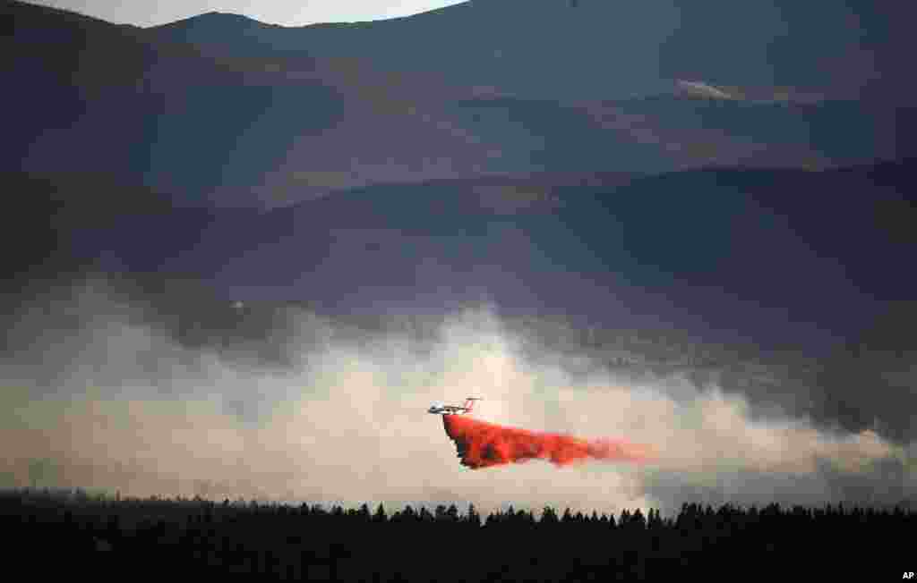 A plane drops retardant while battling the Cold Springs Fire near Nederland, as viewed from Sugarloaf, Colorado, July 10, 2016.
