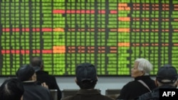 Wawekezaji waangalia harakati masoko ya Hisa ya kampuni ya biashara huko Hangzhou, China. Baadhi ya hisa kubwa zilianguka kutokana na mlipuko wa kirusi corona kuendelea kuenea huko China, Februari 3, 2020.