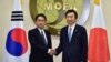 South Korean Foreign Minister Yun Byung-Se, right, and his Japanese counterpart Fumio Kishida pose for a photo at the start of their meeting at Foreign Ministry in Seoul, Dec. 28, 2015. 