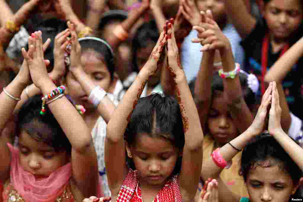 Schoolchildren offer prayers to pay tribute to the victims of the Bastille Day truck attack in Nice, at a school in Ahmedabad, India.