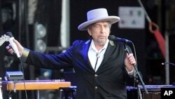 FILE - This July 22, 2012, photo shows U.S. singer-songwriter Bob Dylan performing onstage at "Les Vieilles Charrues" Festival in Carhaix, western France.