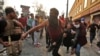 Iraqi anti-government protesters carry away an injured comrade amid clashes with security forces by Baghdad's Rasheed Street near Ahrar Bridge, Nov. 29, 2019. 