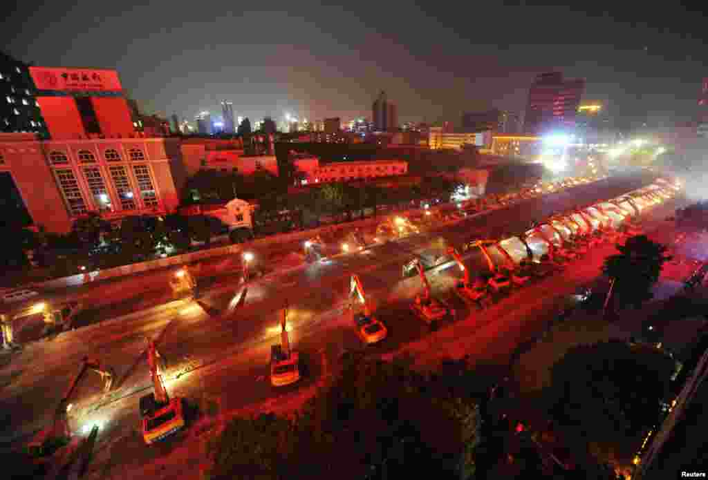 Heavy machinery line up to demolish a bridge in Nanchang, Jiangxi province, China, August 26.