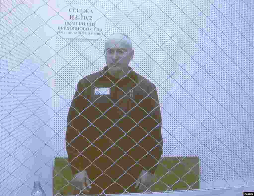 Jailed oil tycoon Mikhail Khodorkovsky is seen on a screen during an appeal for a reduced sentence at Russia's Supreme Court in Moscow August 6, 2013.