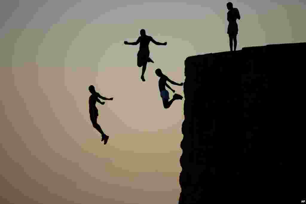 Israeli Arab boys jump into the Mediterranean sea from the ancient wall surrounding the old city of Acre, northern Israel.