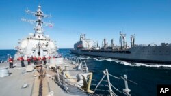 FILE - Oiler USNS John Lenthall is shown in the Gulf of Oman, Dec. 24, 2015. A new oiler will be named after gay rights icon Harvey Milk.