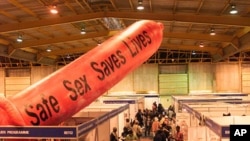 A giant condom inflates over the exhibition stands at Nasrec Exhibition Center, Johannesburg, South Africa, August 2002. (AP Photo/Obed Zilwa)