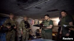 Ukraine's President Volodymyr Zelenskyy awards members of the Ukrainian Special Operation Forces at their position near the frontline town of Bakhmut, amid Russia's attack on July 29, 2023. (Ukrainian Presidential Press Service/via Reuters) 