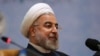 FILE - Iranian President Hassan Rouhani sits while attending the 27th International Islamic Unity Conference in Tehran, Iran, Jan. 17, 2014.
