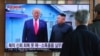 FILE - People watch a TV screen showing a file image of North Korean leader Kim Jong Un and U.S. President Donald Trump, left, during a news program at the Seoul Railway Station in Seoul, South Korea, Dec. 31, 2019. 