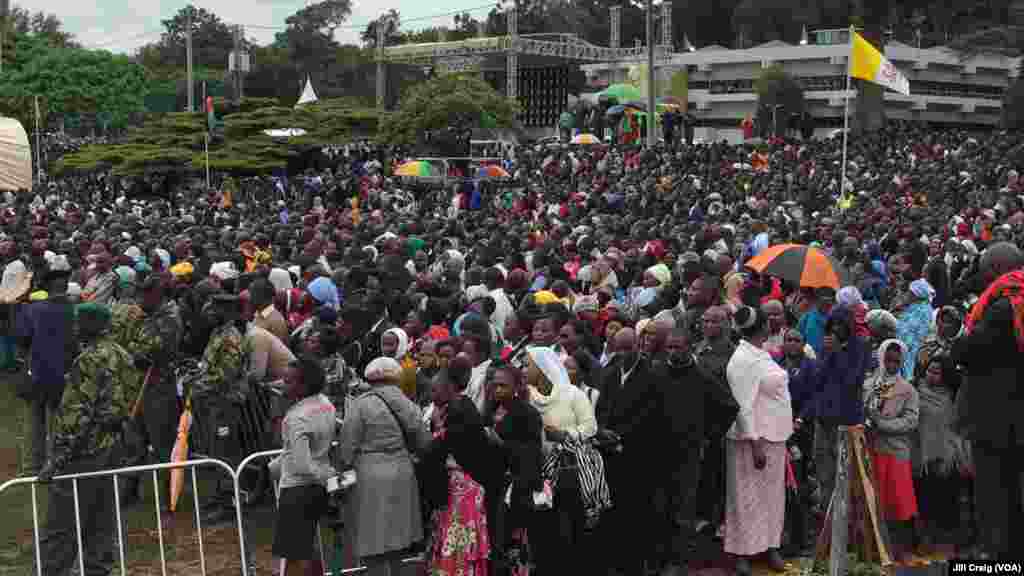 People gather to attend a Mass celebrated by Pope Francis, at the campus of the University of Nairobi, Kenya, Nov. 26, 2015.