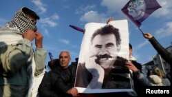 FILE - A demonstrator holds a picture of jailed Kurdish militant leader Abdullah Ocalan during a rally in Diyarbakir, Turkey, Feb. 27, 2025.