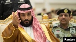 Saudi Crown Prince Mohammed bin Salman gestures during a military parade by Saudi security forces in Mecca, Saudi Arabia, Aug. 23, 2017.
