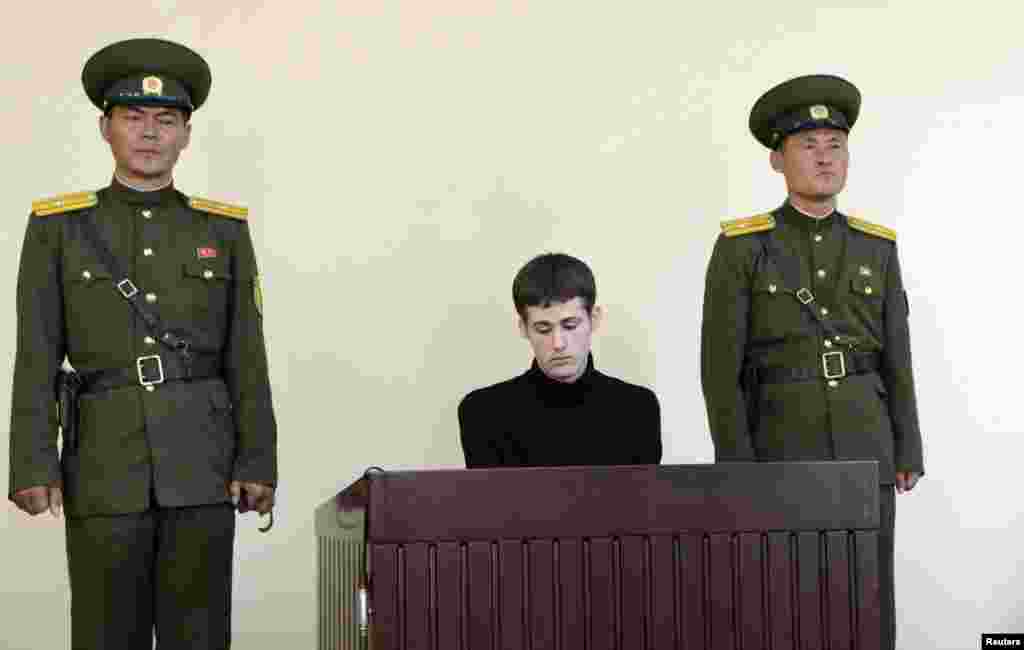 U.S. citizen Matthew Todd Miller sits in a witness box during his trial at the North Korean Supreme Court in this undated photo released by North Korea's Korean Central News Agency (KCNA), in Pyongyang, North Korea, Sept. 14, 2014.