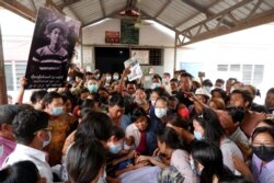 People mourn as they attend the funeral of Kyaw Win Maung, who was shot and killed during a protest against the military coup, in Mandalay, Myanmar, March 28, 2021.