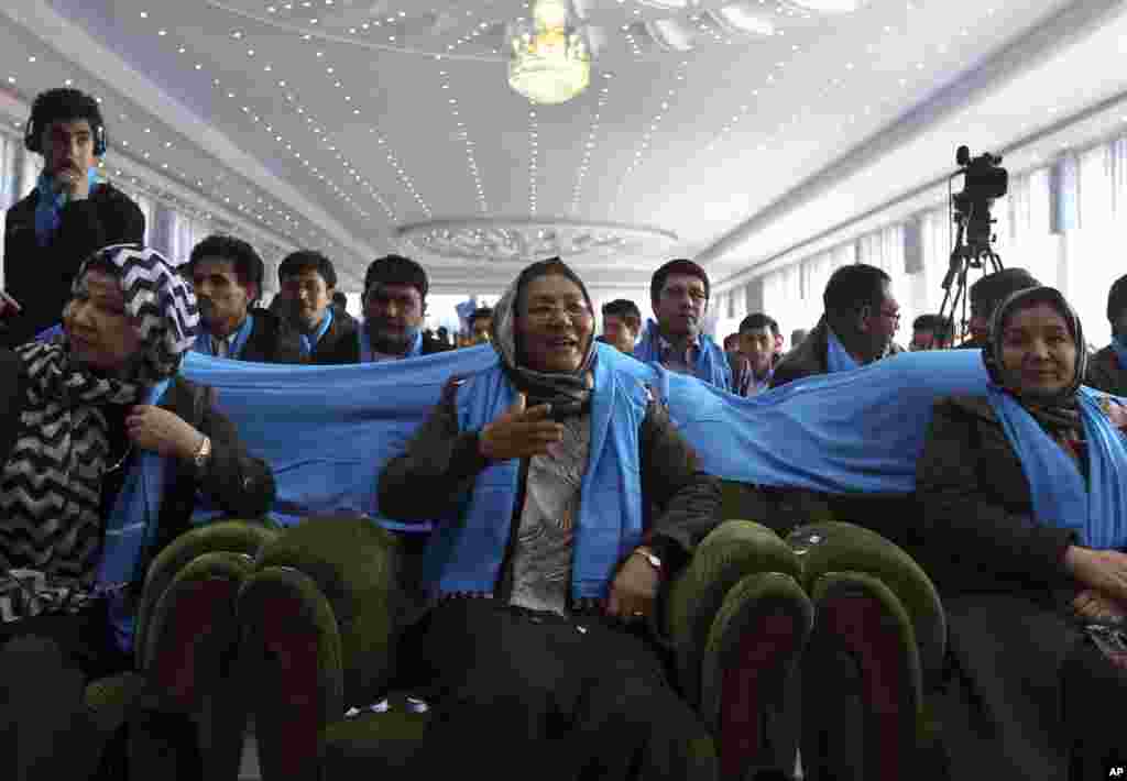 The deeply conservative, all-male crowd at Afghanistan's Kandahar stadium watch as vice-presidential candidate, Habiba Sarabi, in a headscarf stood up and reached for the microphone, Kabul, March 17, 2014.