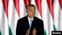 FILE - Hungarian Prime Minister Viktor Orban applauds at an event in Budapest, Hungary, April 5, 2019.